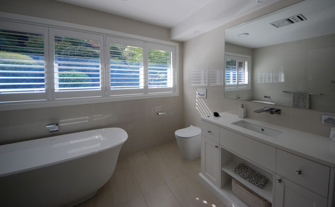 Corner view of a bathroom with long windows